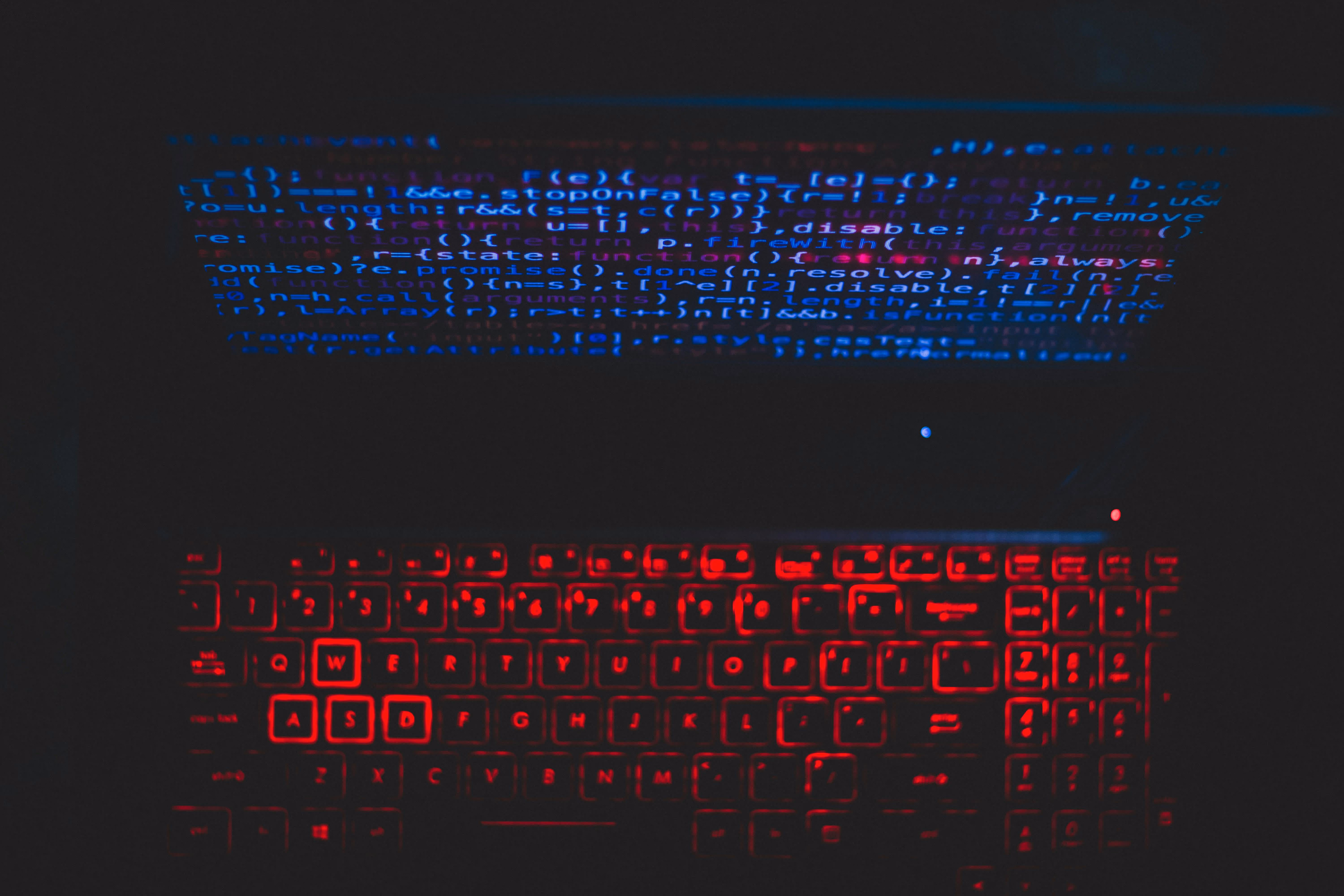 Red Keyboard Next To Code On A Screen